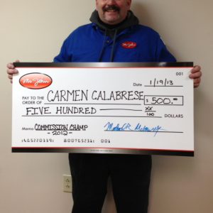 Photo of Mr. John 2012 commission contest winner Carmen Calabrese holding giant check for $500